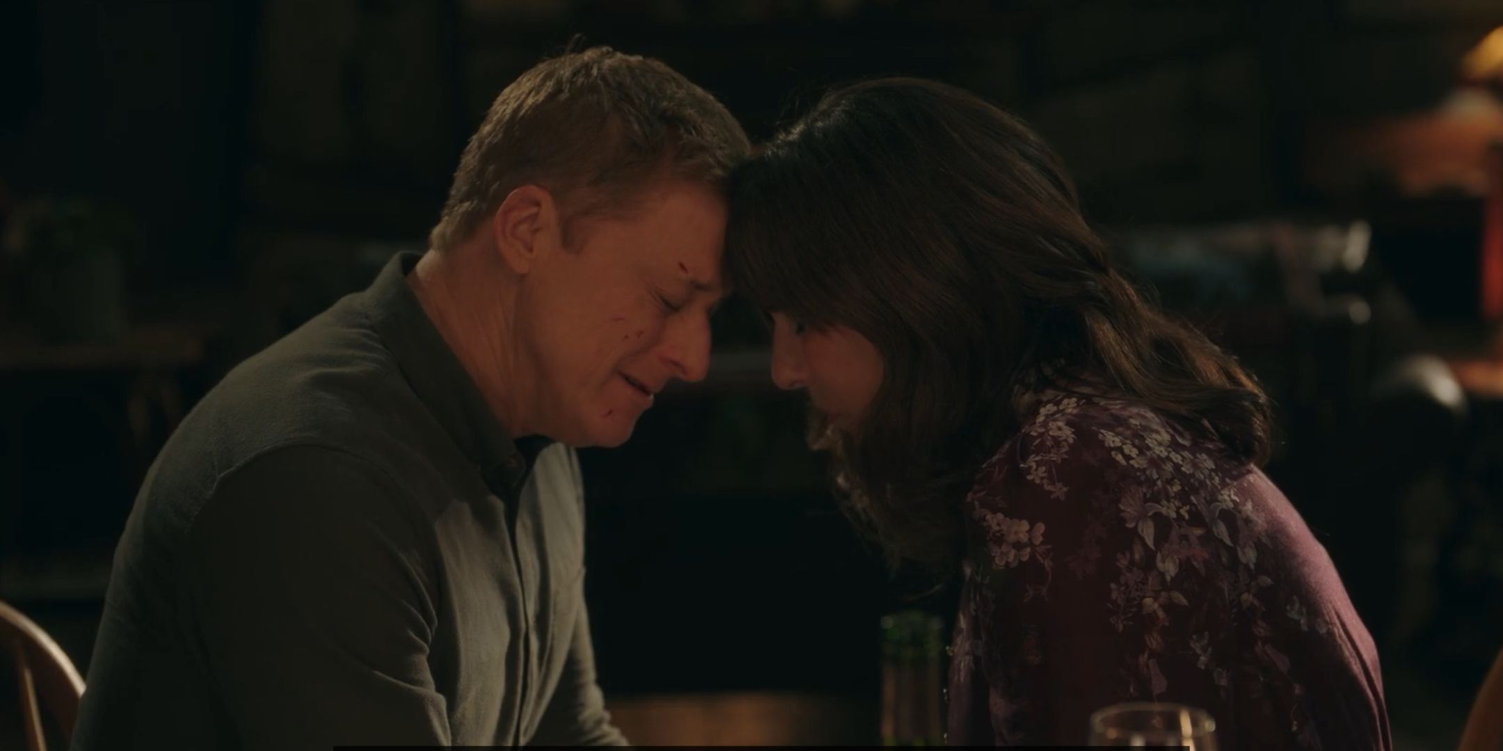 Harry and Heather with their heads together in Resident Alien