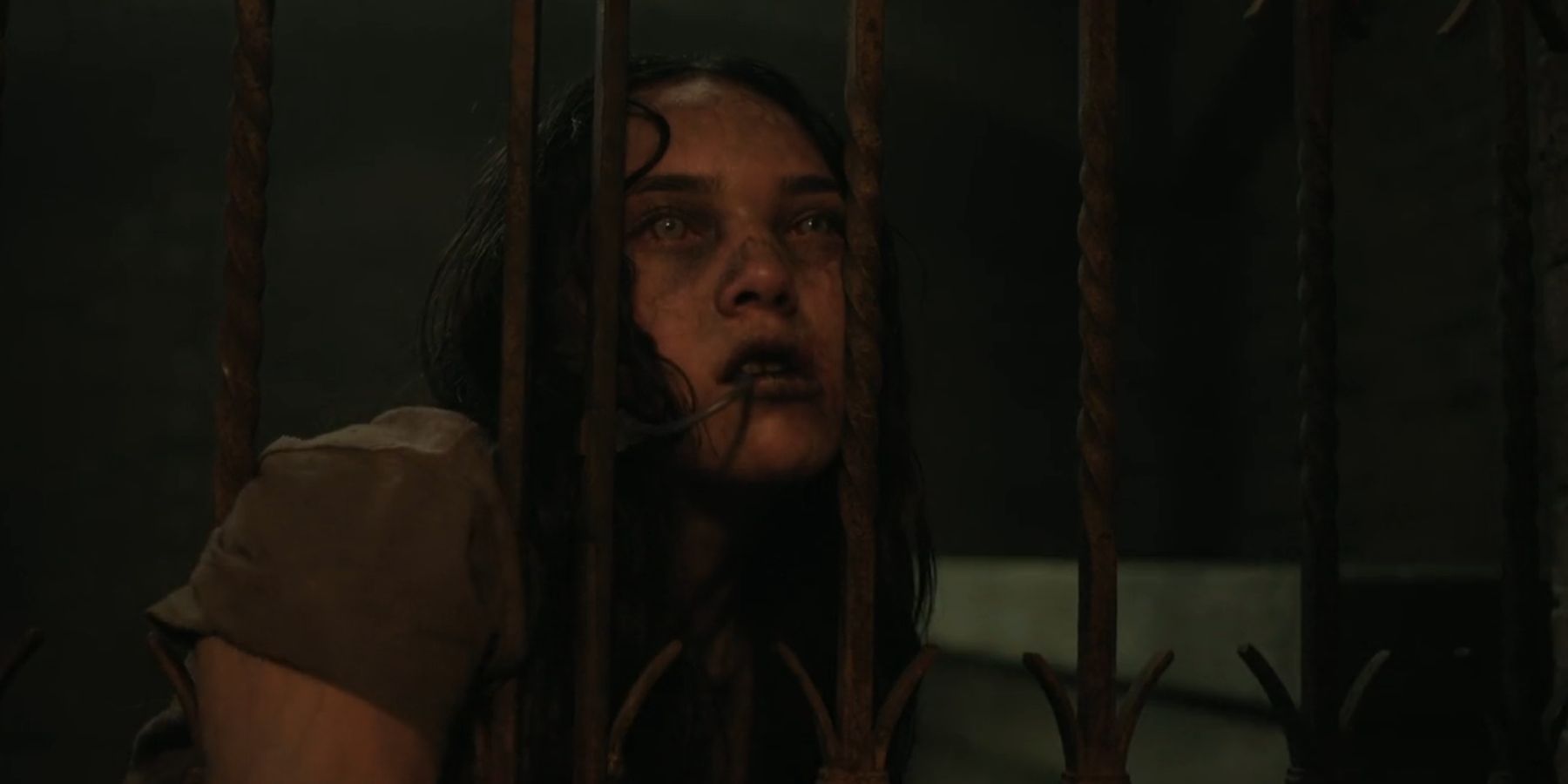 A zombified Ginny with her head pressed against her cell in The Walking Dead: Dead City season 2
