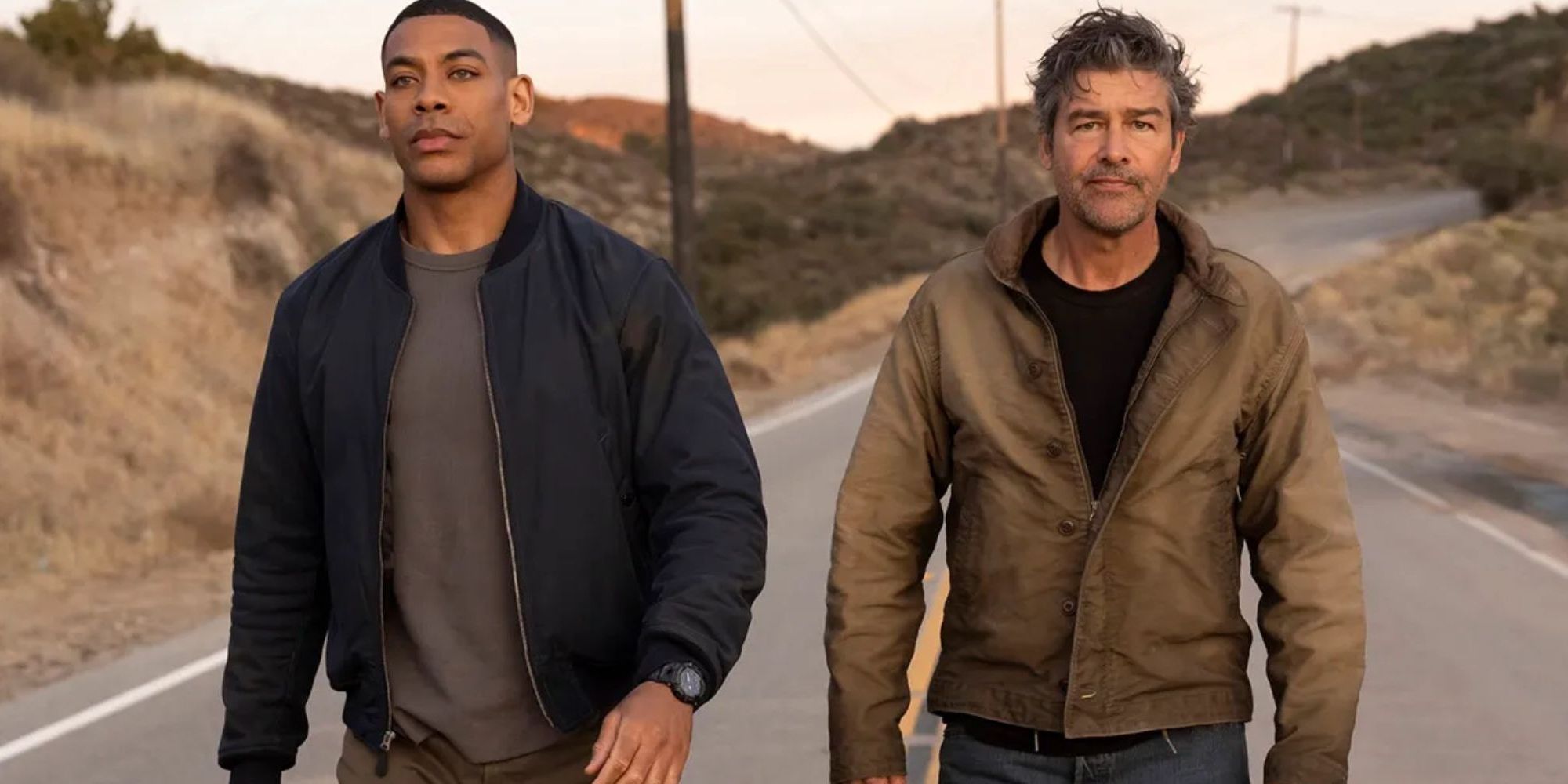 Aaroin Pierre's John Stewart and Kyle Chandler's Hal Jordan walk down a road in Lanterns