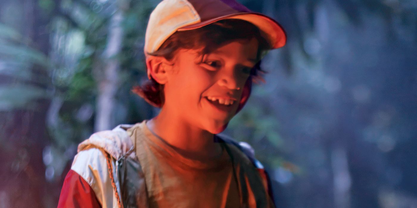 Acston Luca Porto as Sonny smiling while lit by a fire in Dora and the Search for Sol Dorado