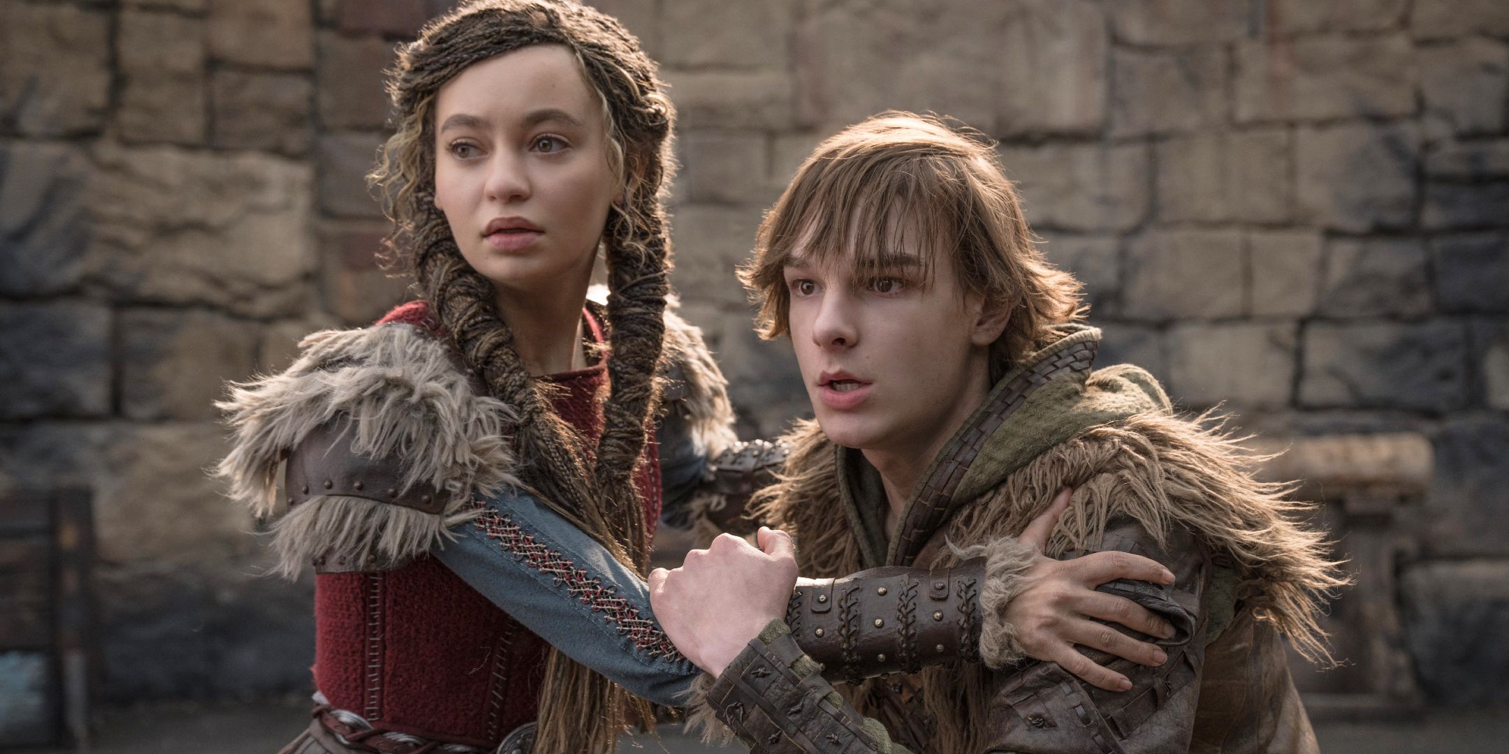 Astrid holding onto a cowering Hiccup in How to Train Your Dragon 2025