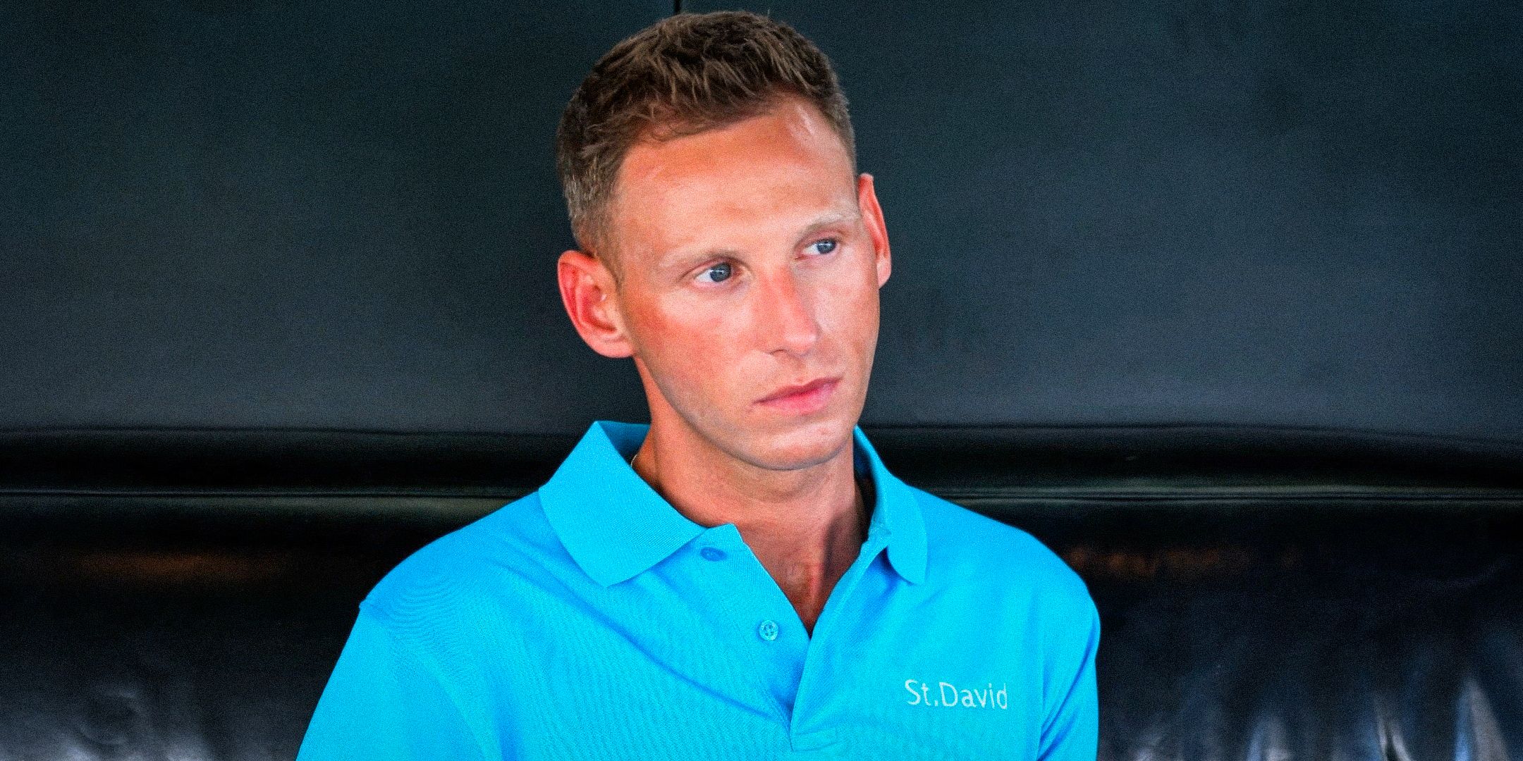 Below Deck Fraser Olender standing in uniform with a concerned look on his face