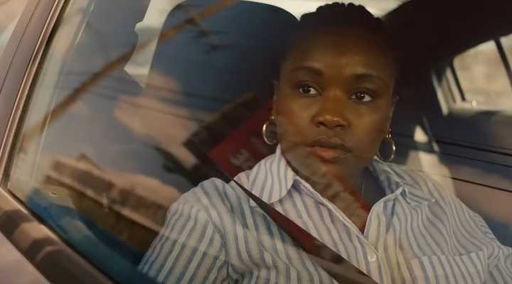 Courtney Taylor as Samira Parker looking out of the car window thoughtfully in Ballard