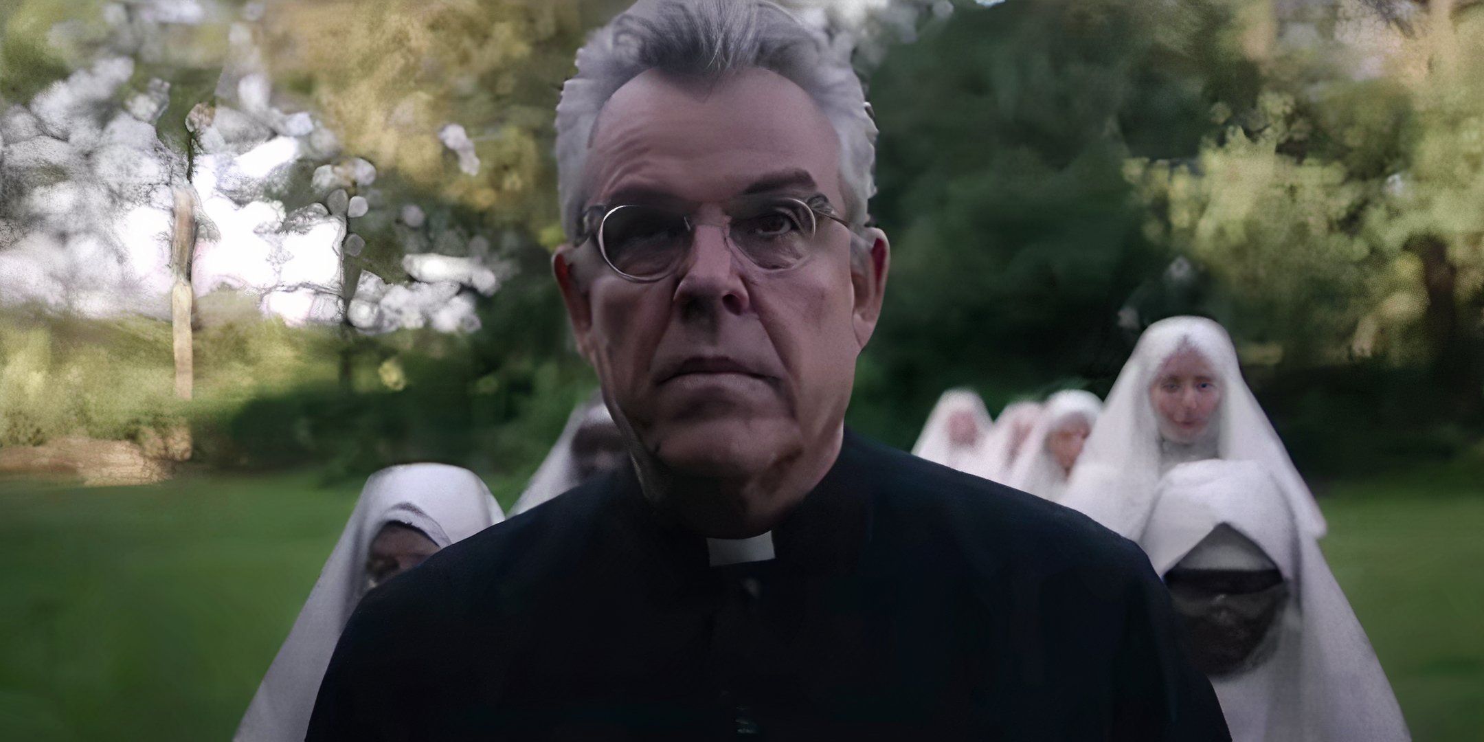 Danny Huston as Father Romero leading a group of nuns into a church in Consecration