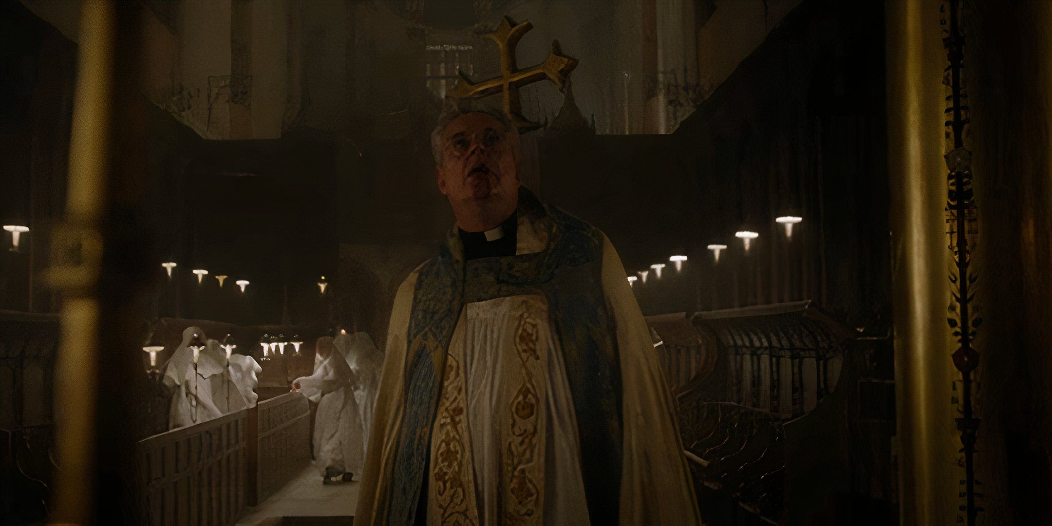 Danny Huston's Father Romero impaled by a golden cross in Consecration