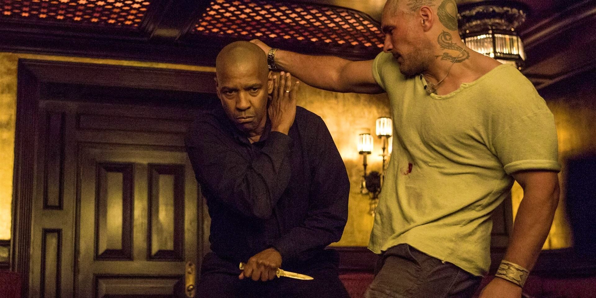 Denzel Washington as McCall holding a knife and fighting a gangster in The Equalizer