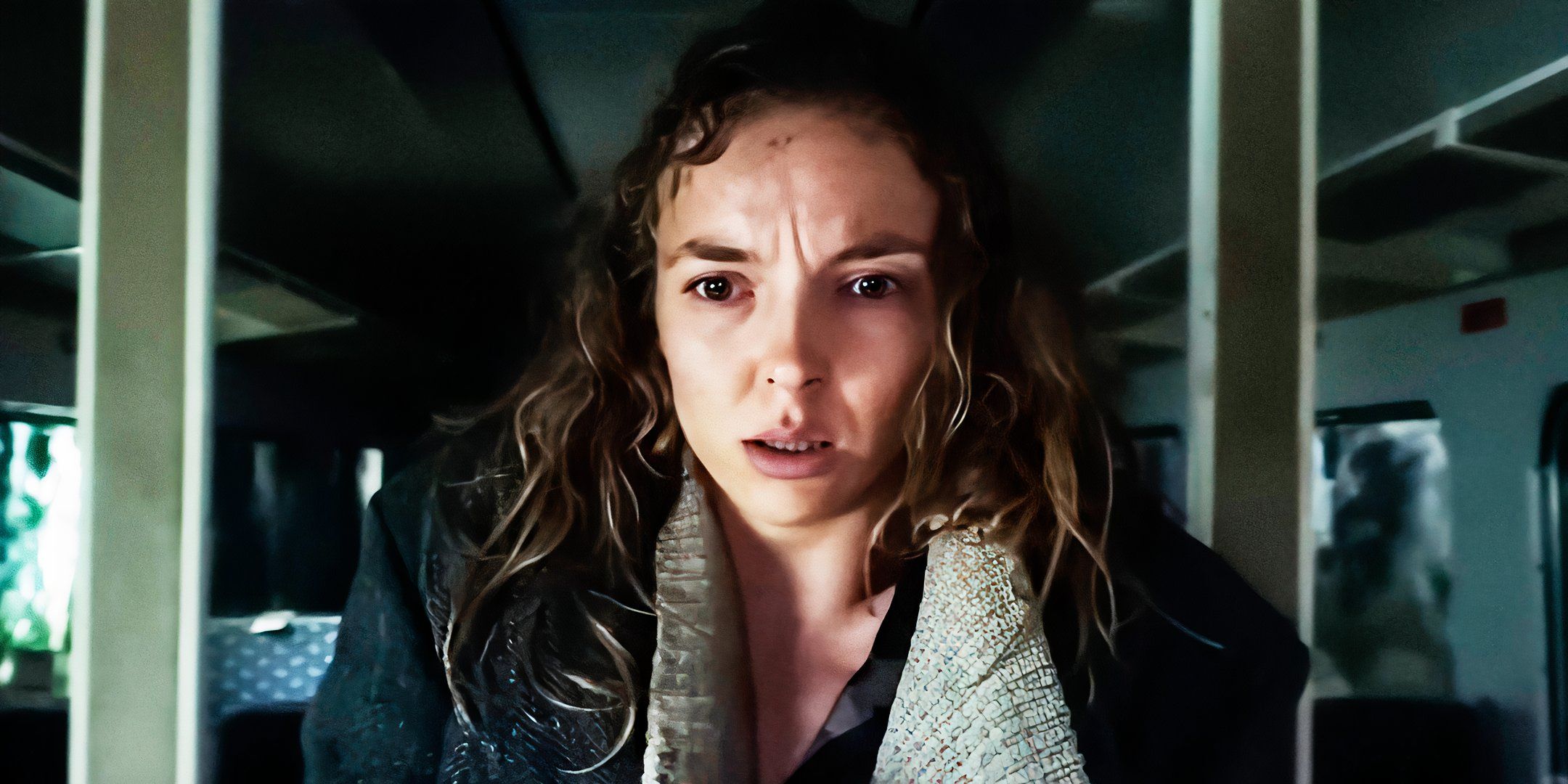 Jodie Comer looking at something with a disturbed expression in 28 Years Later