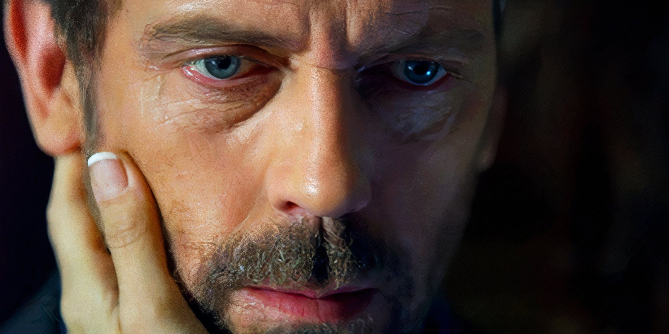 Hugh Laurie as Dr. Gregory House with a hand around his face in the House episode in