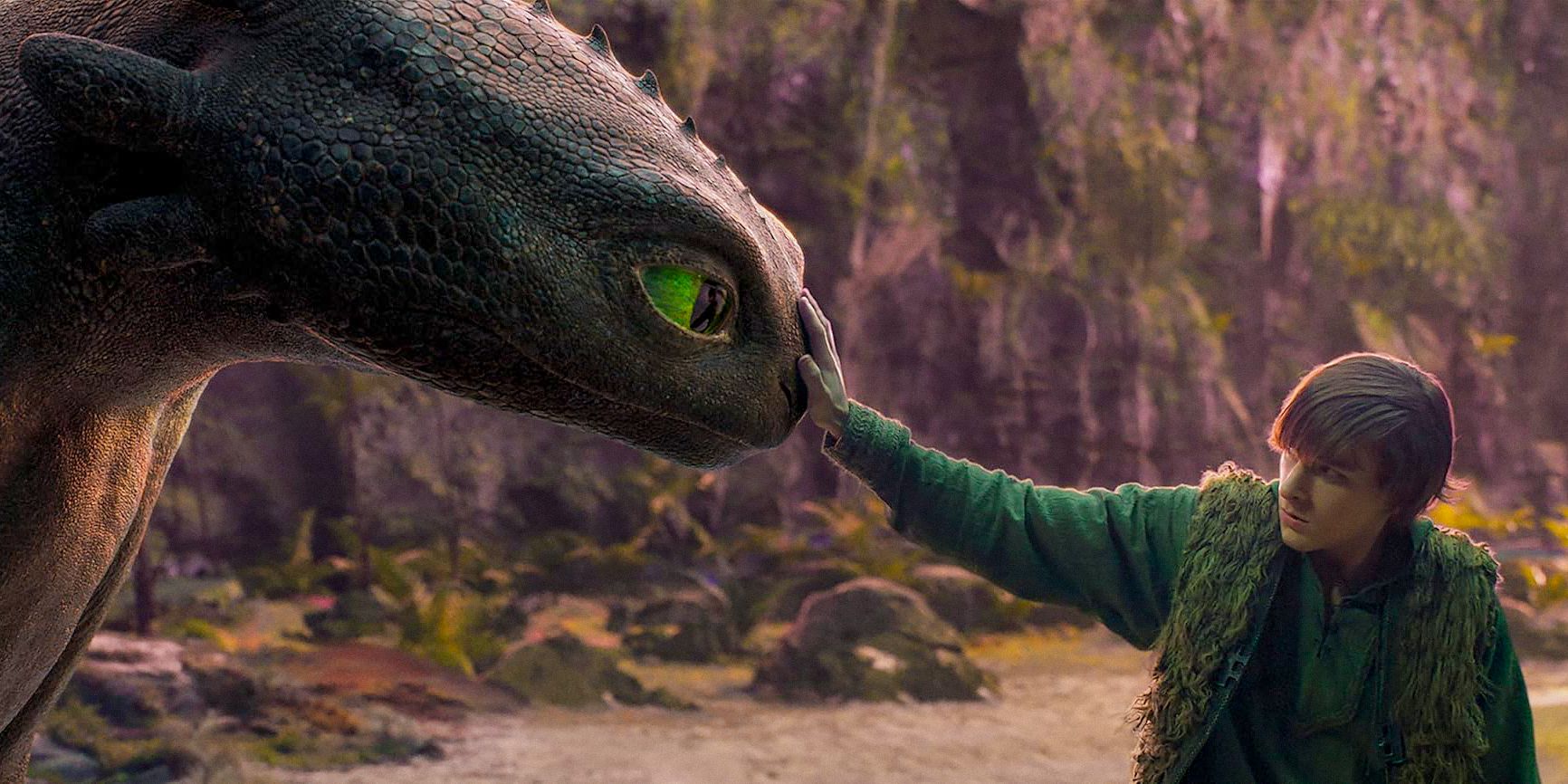 Hiccup (Mason Thames) touching Toothless for the first time in How To Train Your Dragon (2025)