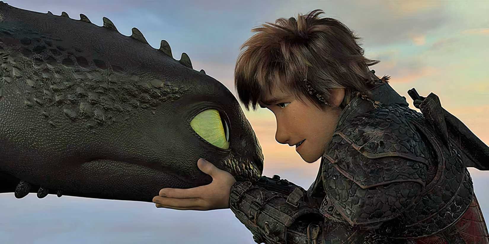 Hiccup holds Toothless' head close as he speaks dramatically in How To Train Your Dragon 3