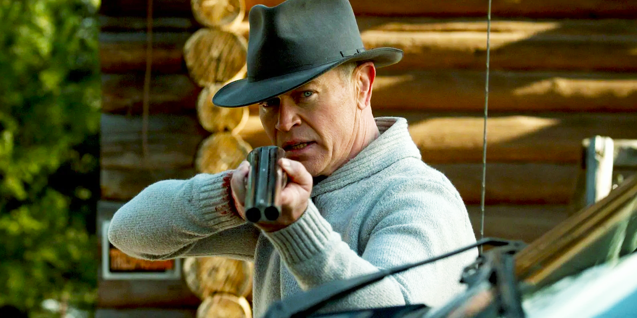 Malcolm Beck (Neal McDonough) pointing a shotgun in Yellowstone.