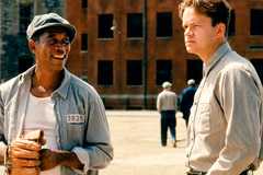 Morgan Freeman as Red Redding and Tim Robbins as Andy Dufresne in the prison yard in Shawshank Redemption