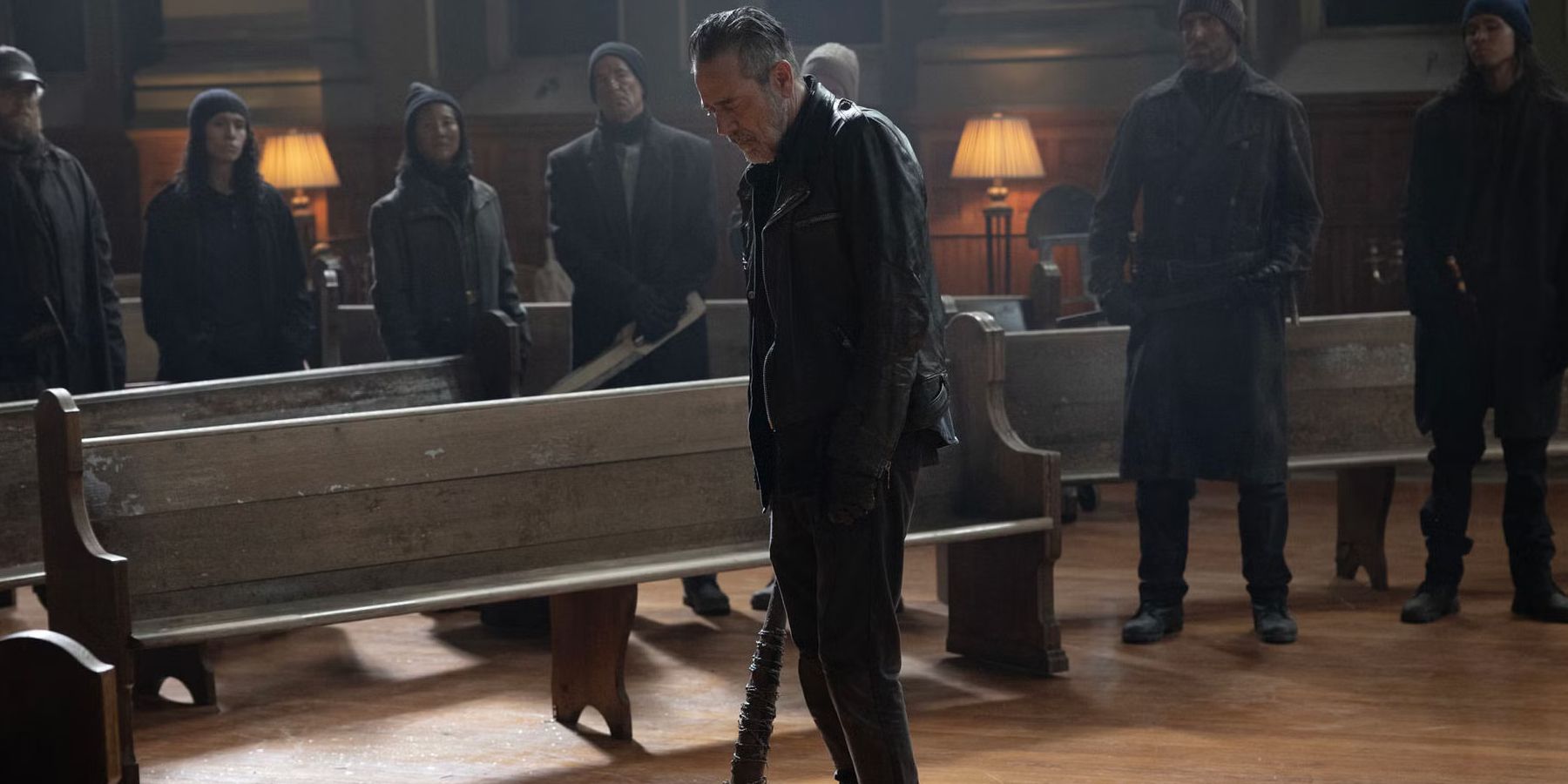 Jeffrey Dean Morgan as Negan looking down while holding his bat in The Walking Dead: Dead City season 2