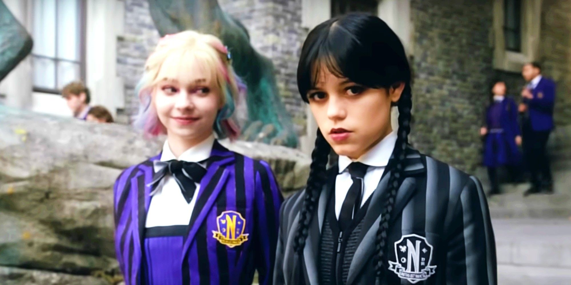OG Addams Family Actor's New Wednesday Season 2 Character Gives The Show A Plot Hole To Quickly Resolve Jenna Ortega as Wednesday Addams looking at the camera and Emma Myers as Enid Sinclair looking at Wednesday in Wednesday season 2 teaser video