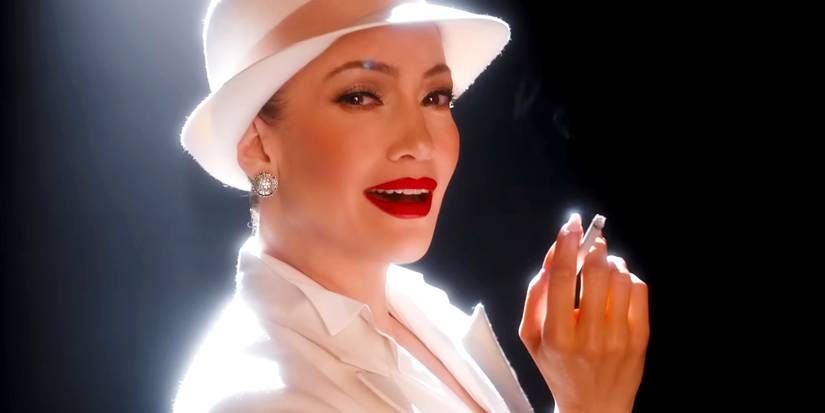 Jennifer Lopez holding a cigarette in a spotlight in Kiss of the Spider Woman 2025