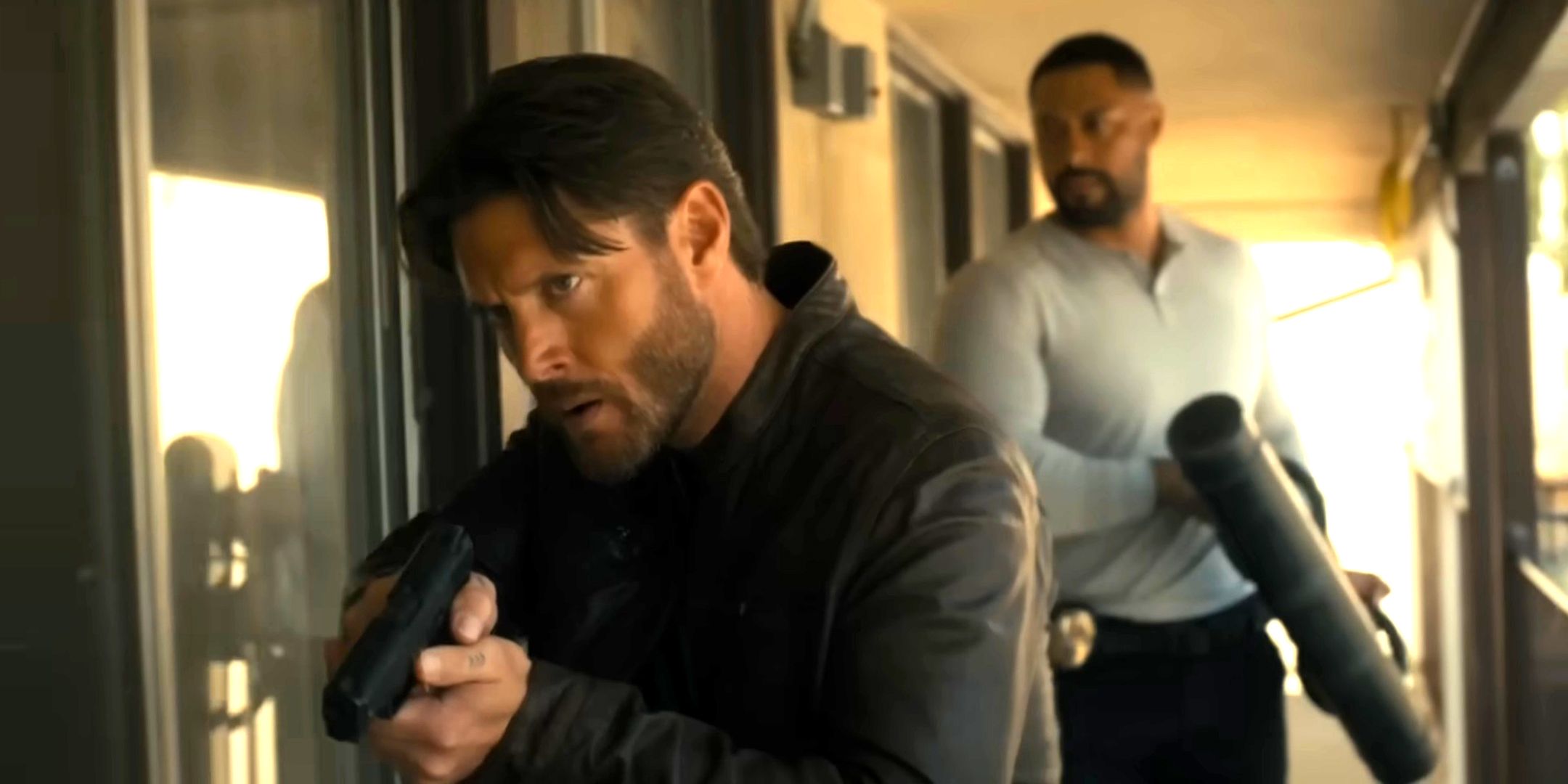 Jensen Ackles' Meachum walking with his gun drawn and Uli Latukefu's Finau carrying the breacher behind him in Countdown season 1