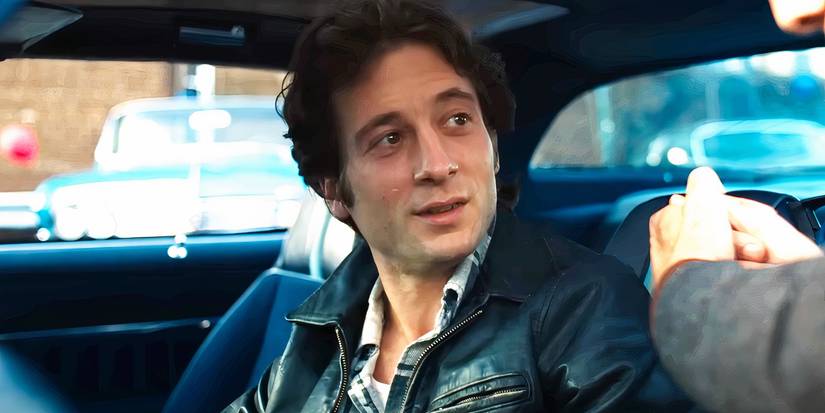 Jeremy Allen White talking to a car dealer in Deliver Me From Nowhere