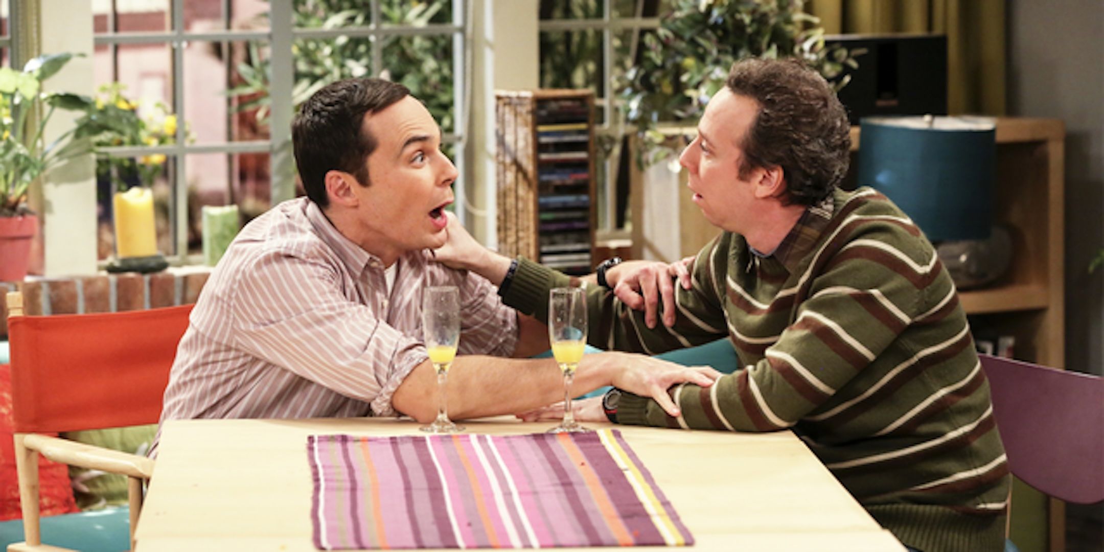 Jim Parsons' Sheldon grabs Kevin Sussman's Stuart at a kitchen table from The Big Bang Theory