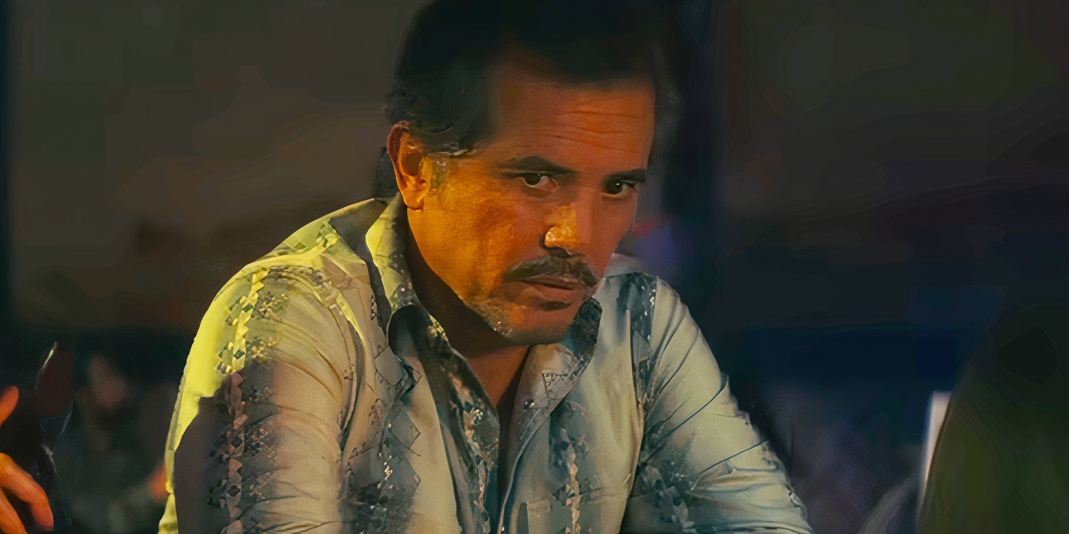 John Leguizamo as Esposito sitting at a bar in Smoke
