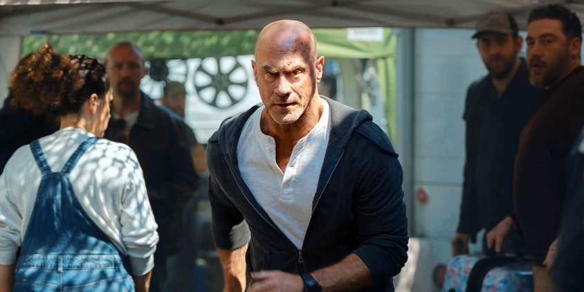 Eliot Stabler running through a crowd in Law & Order: Organized Crime
