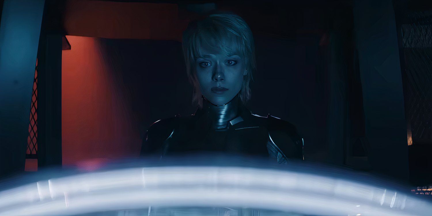 AMELIA looking at a glowing device in M3GAN 2.0