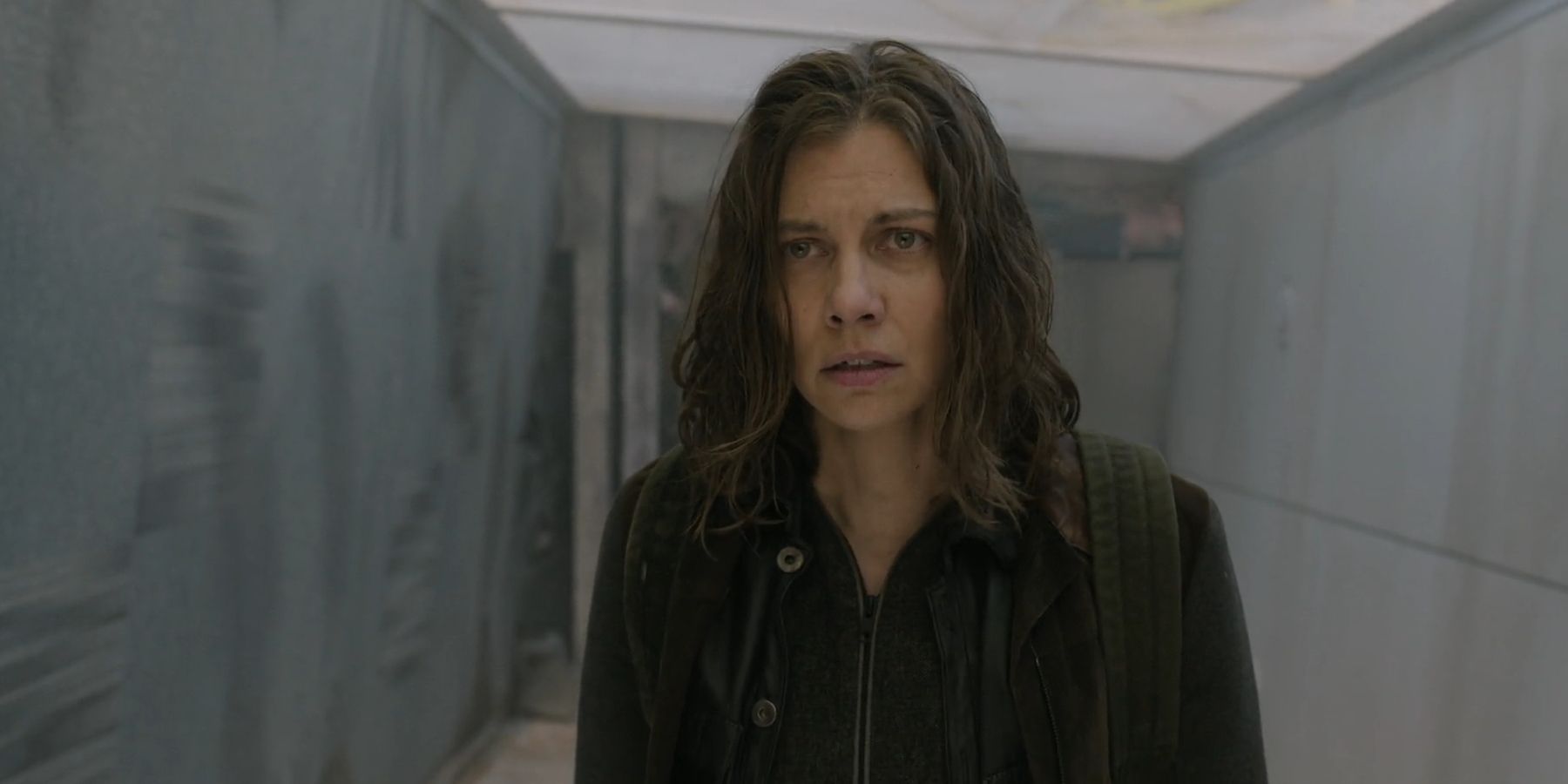 Maggie (Lauren Cohan) looking tired as she crosses a bridge in The Walking Dead: Dead City season 2