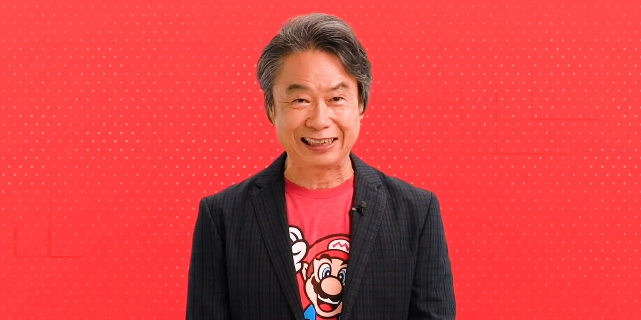 Miyamoto in front of a red Nintendo background