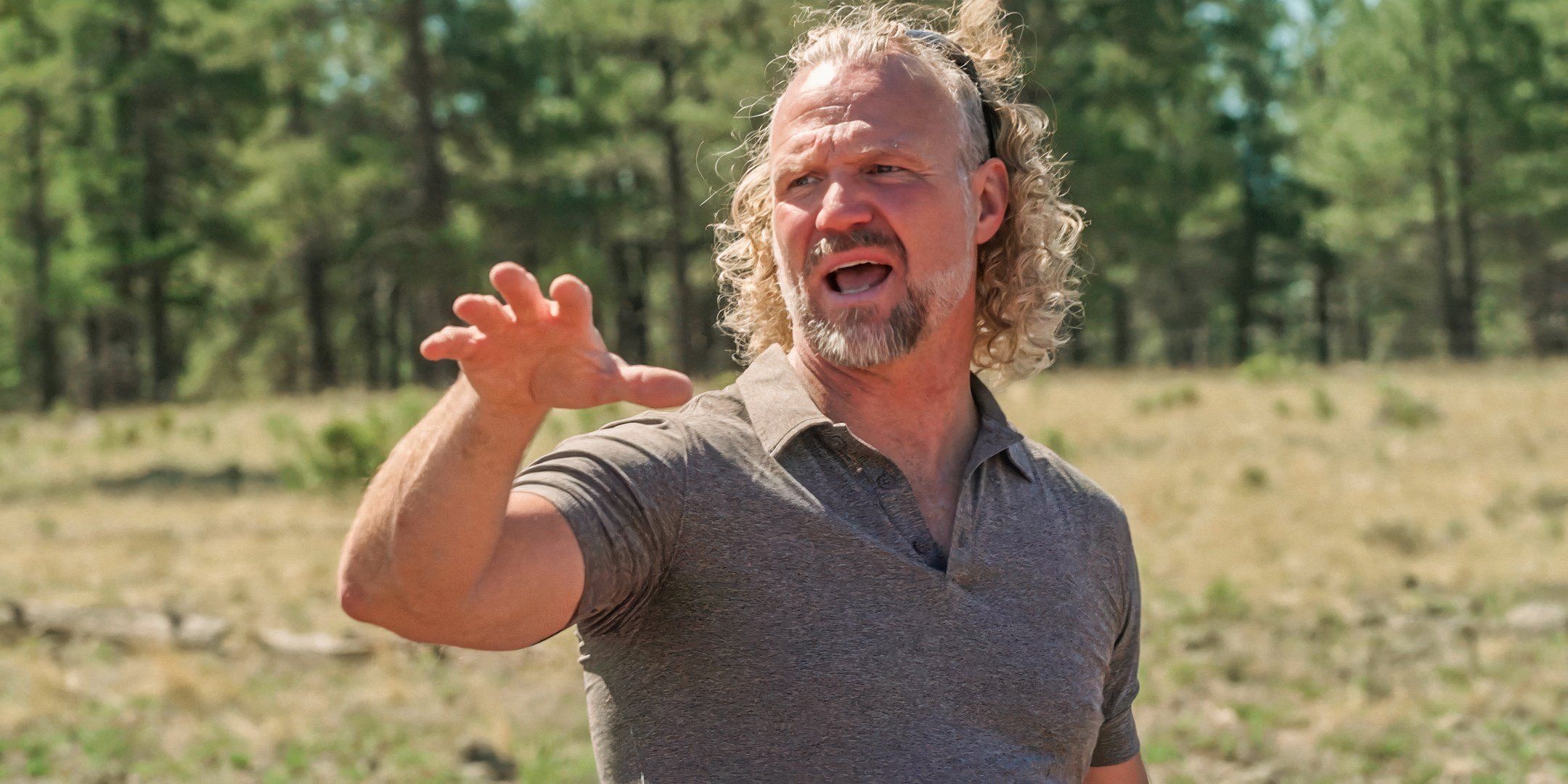 Kody Brown in Sister Wives in grey shirt outside, arguing