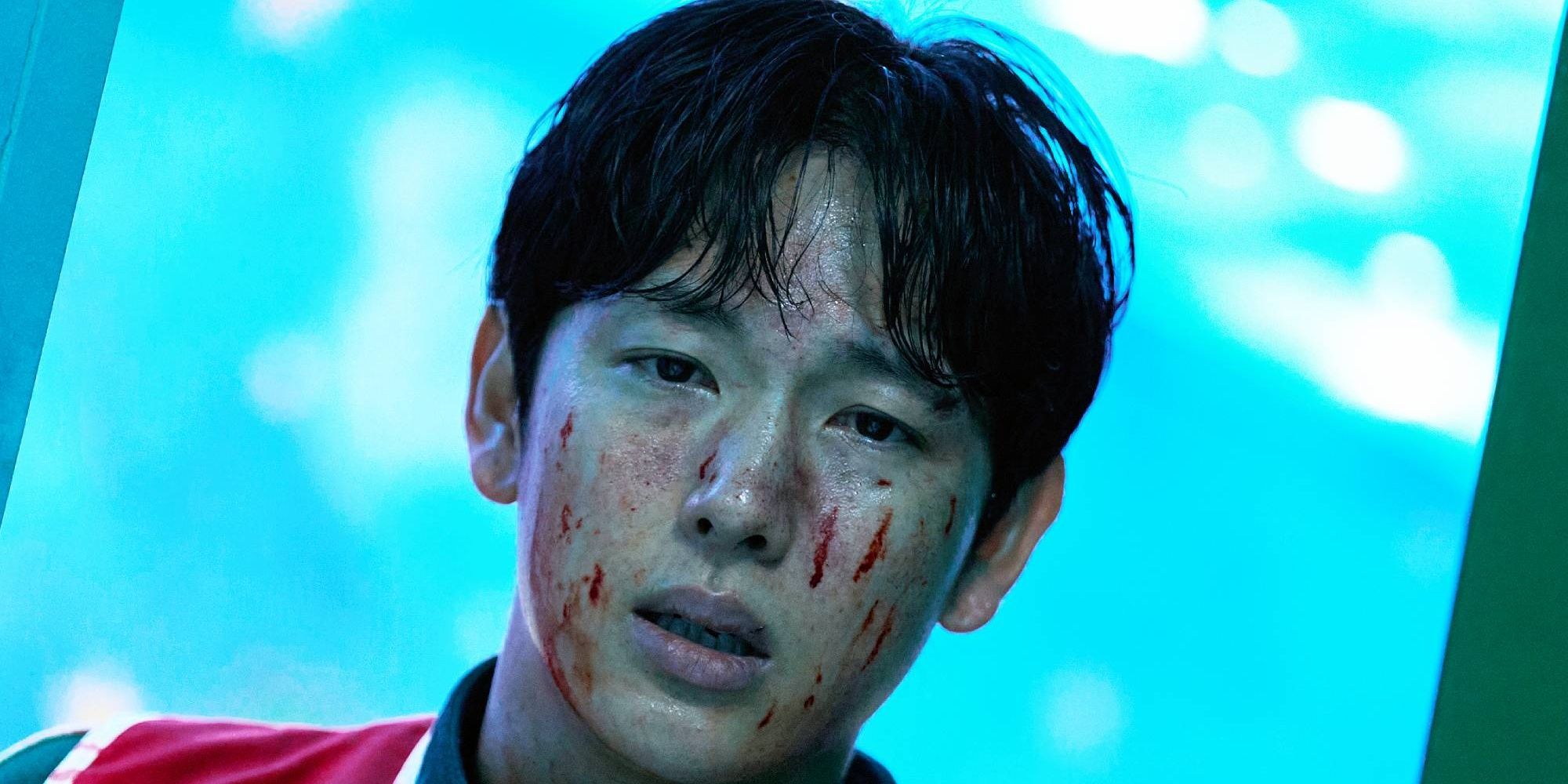 Myung-gi with a bloodied face, staring ahead, in Squid Game season 3