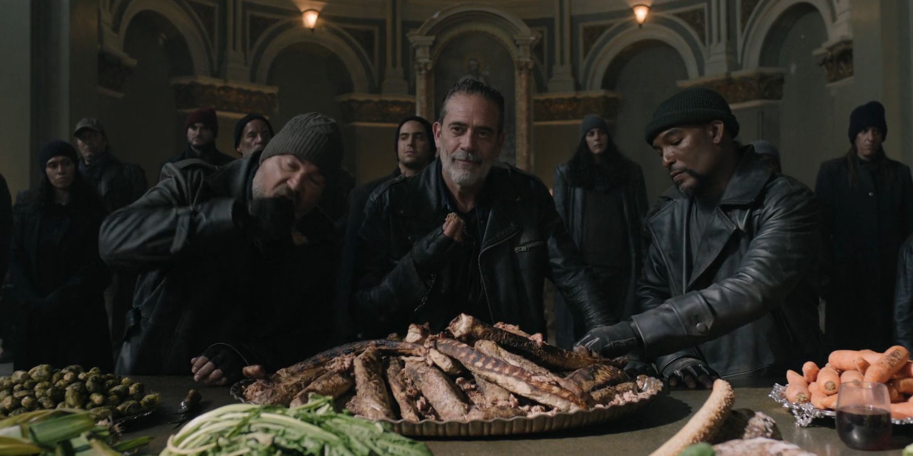 Negan (Jeffrey Dean Morgan) and the Burazi eating a feast in The Walking Dead: Dead City season 2
