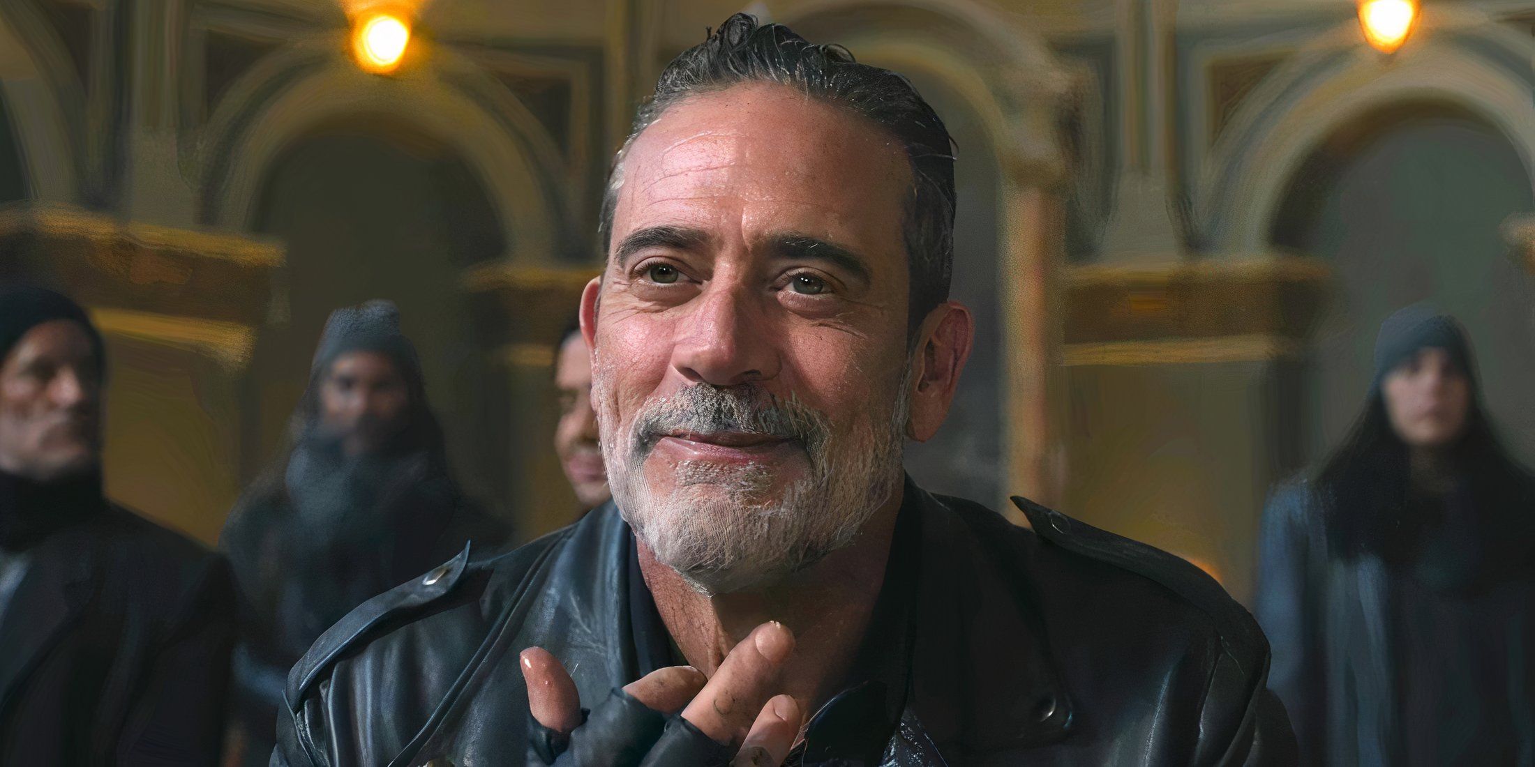 Negan with a wry smile while licking his fingers in The Walking Dead Dead City season 2 episode 8