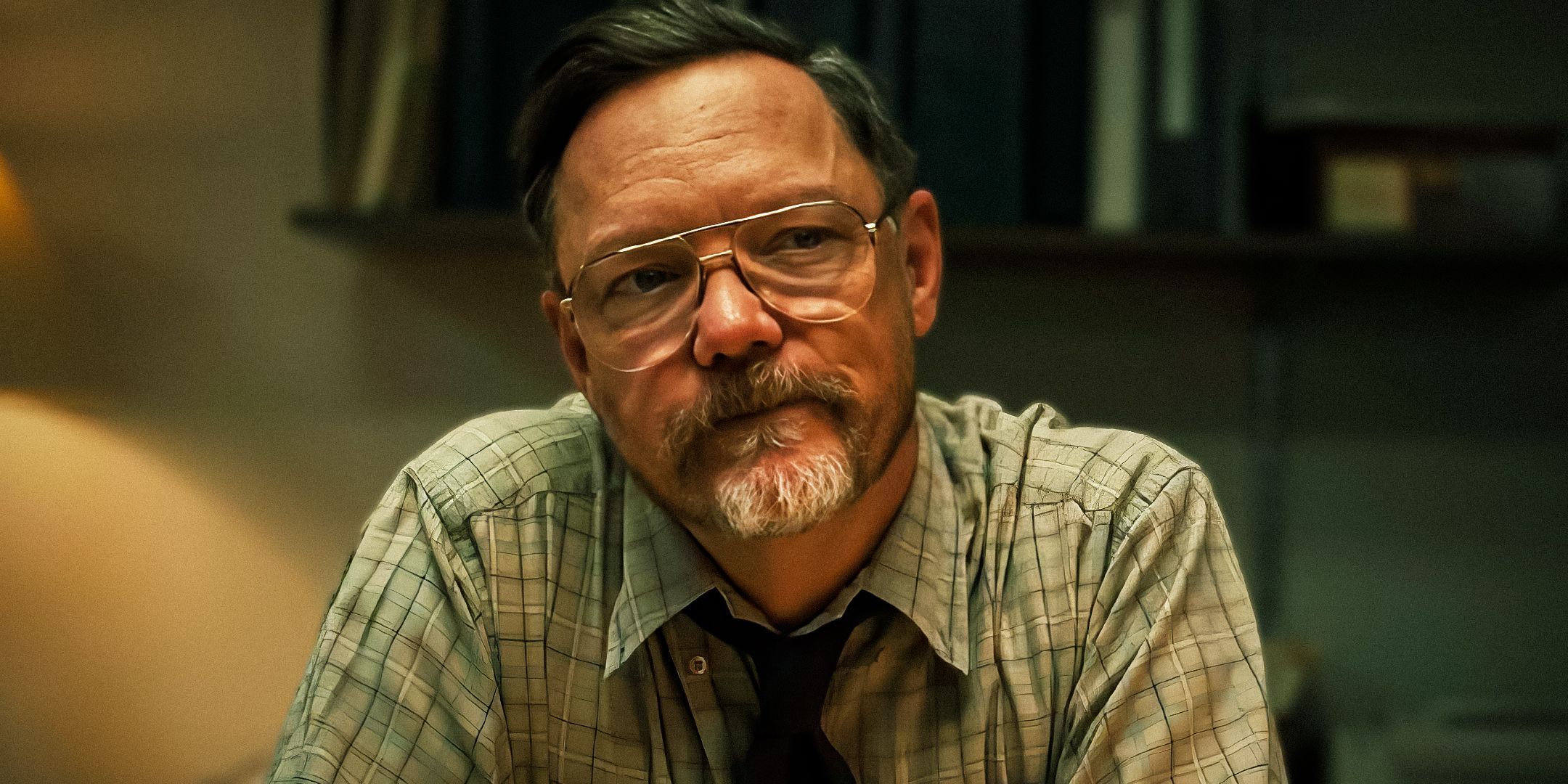 Matthew Lillard as William Afton sitting at his desk in Five Nights at Freddy's