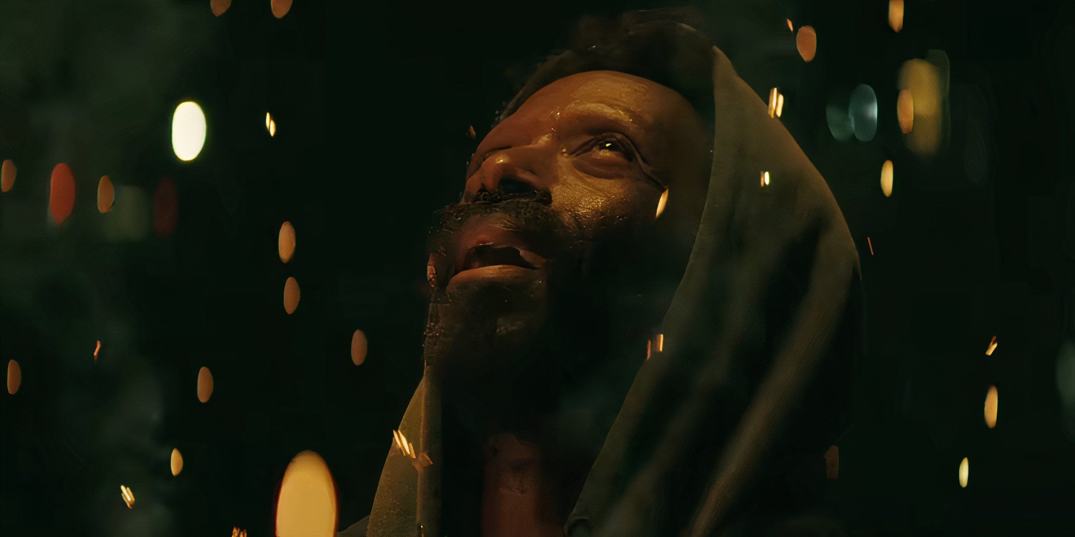 Ntare Mwine as Freddy Fasano looking up at embers in Smoke