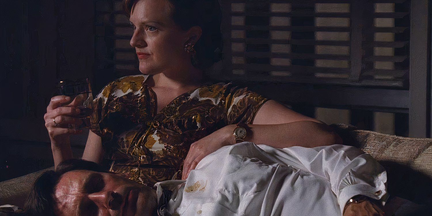 Don lies in Peggy's lap in Mad Men. Peggy is holding a drink and Don looks worse for wear, with vomit on his shirt.