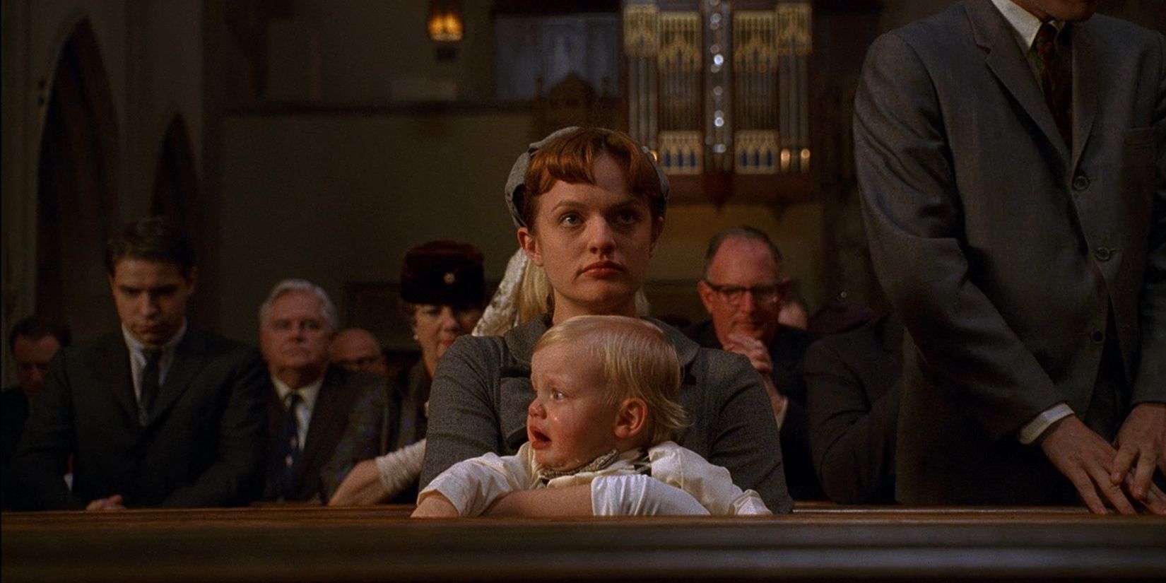 Peggy holds her sister's baby in Mad Men