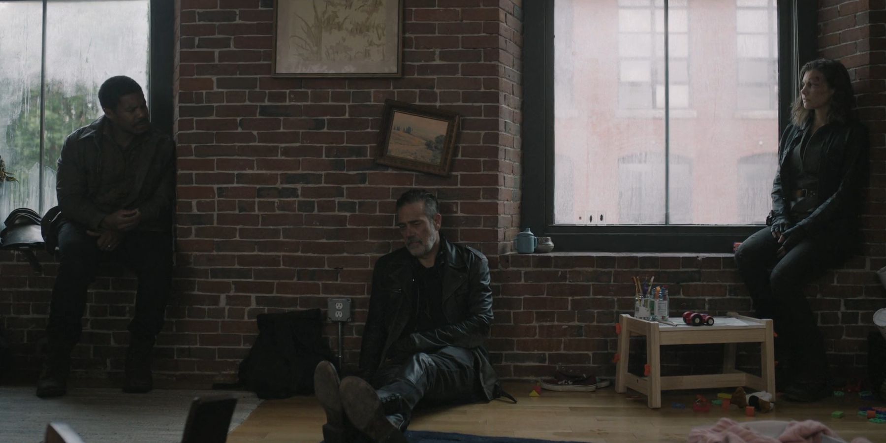 Perlie Armstong (Gaius Armstrong), Negan (Jeffrey Dean Morgan), Maggie (Lauren Cohan) sitting together in The Walking Dead: Dead City season 2