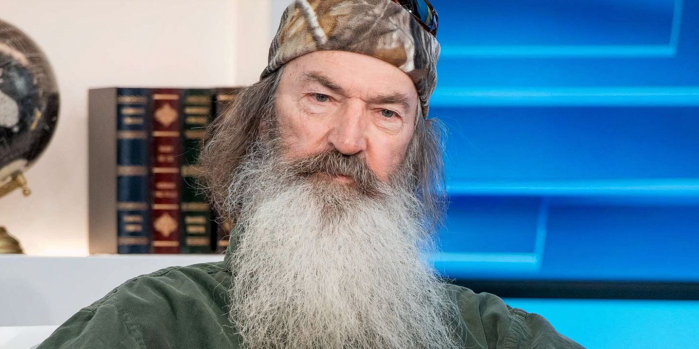 Phil Robertson in Duck Dynasty posing for a photo in green shirt