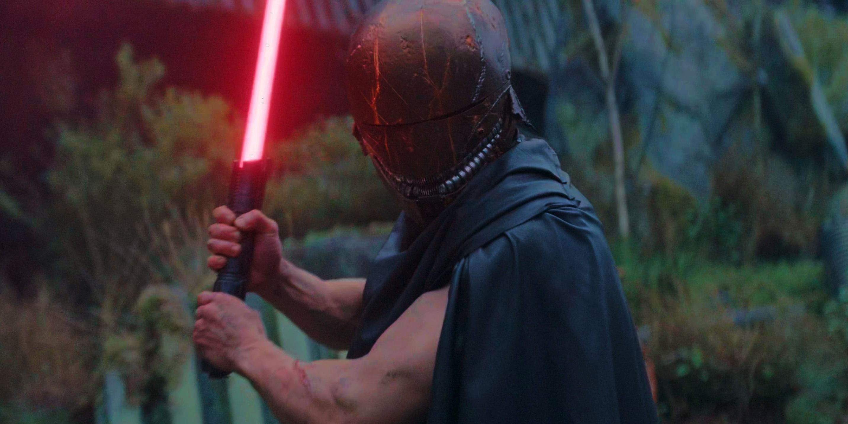 Qimir/the Stranger wielding a red lightsaber in The Acolyte