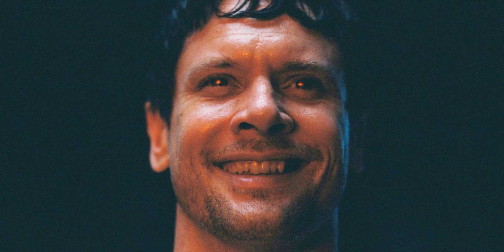 Remmick smiling while his eyes glow red in Sinners