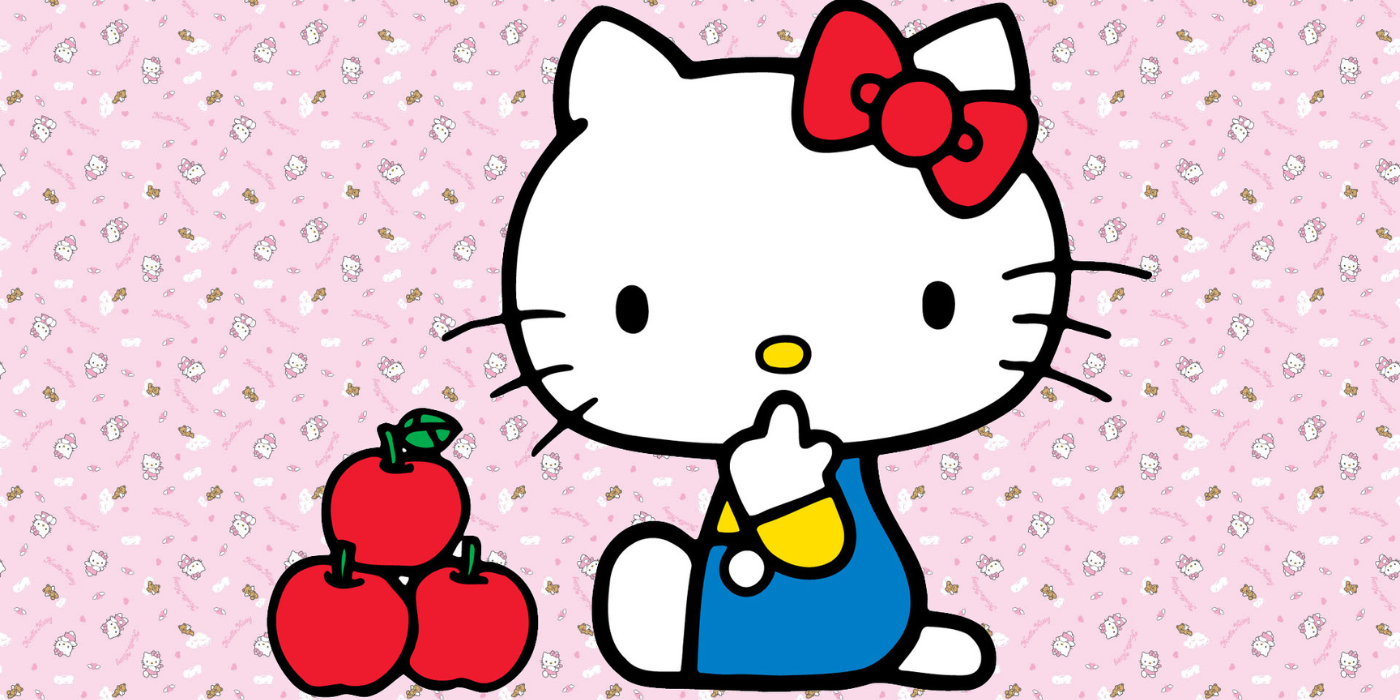 Sanrio Hello Kitty seduta accanto a delle mele