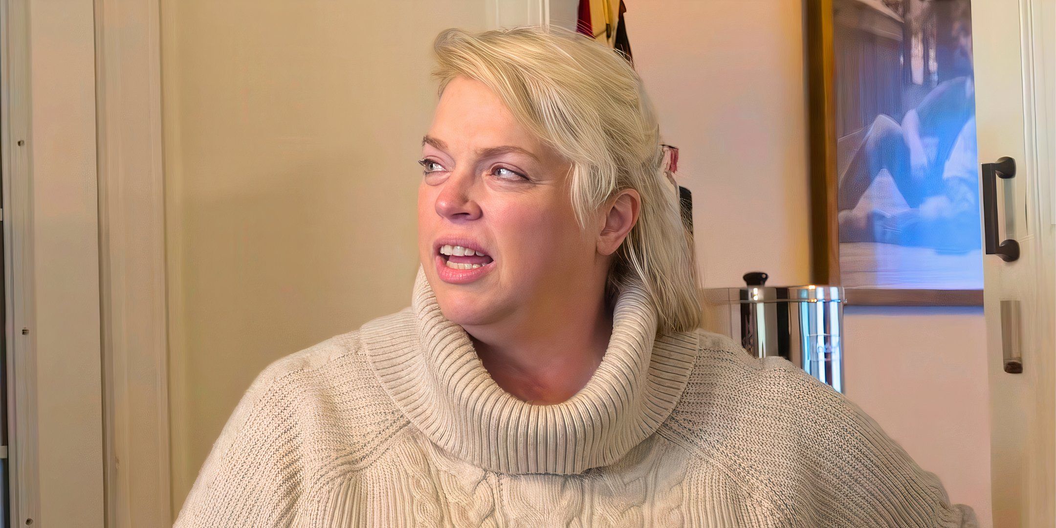 sister wives star janelle brown in a cream turtleneck sweater talking in a kitchen