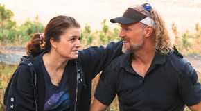 sister wives stars kody and robyn smiling outside with him in a visor