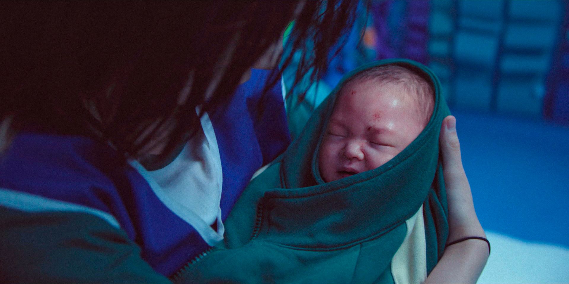A baby, covered in blood and crying in Squid Game season 3