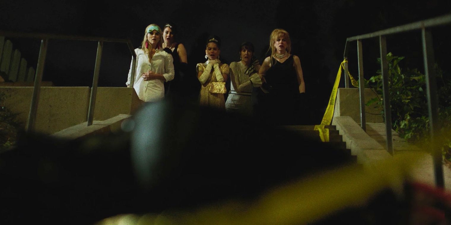 The cast of Big Little Lies looking down at a dead body in the season 1 finale