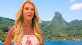 The Golden Bachelorette’s Joan Vassos with a tropical island behind her