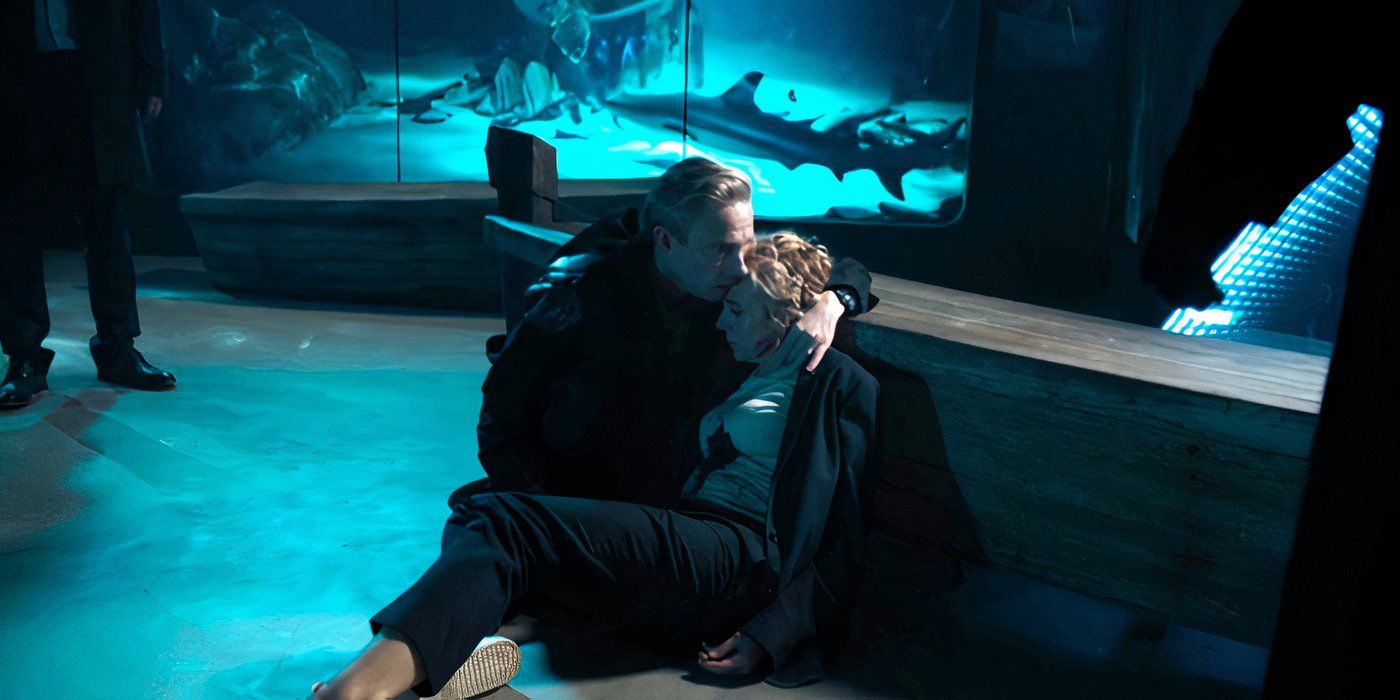 John on the floor holding Mary, who has been shot and has just died, in the Sherlock episode "The Six Thatchers."