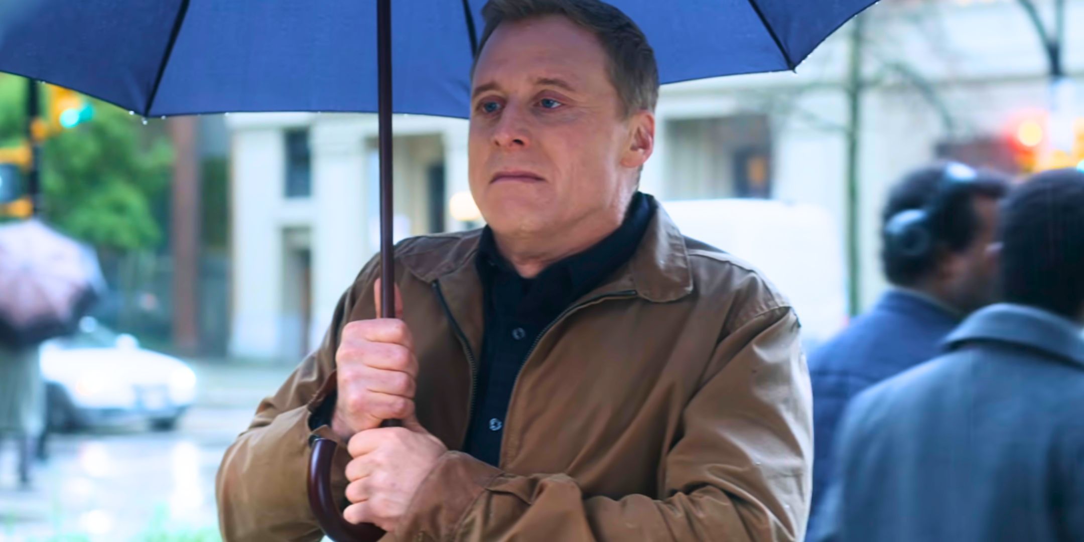 Alan Tudyk holding an umbrella as Harry Vanderspeigle in Resident Alien