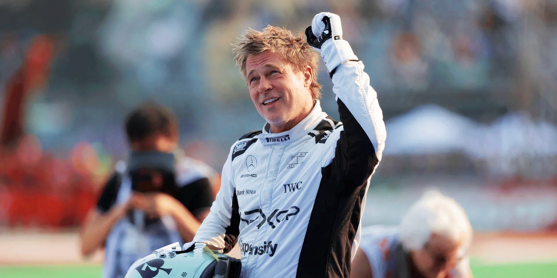 Brad Pitt as Sonny Hayes raising a fist in celebration in F1 The Movie
