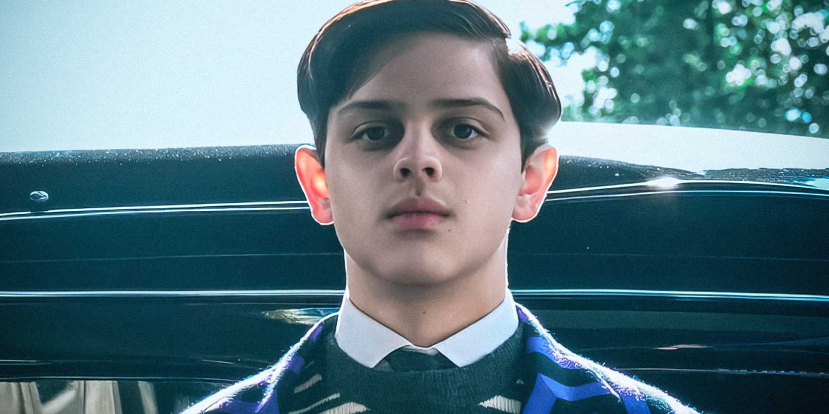 Pugsley stands in front of a car in Wednesday season 2