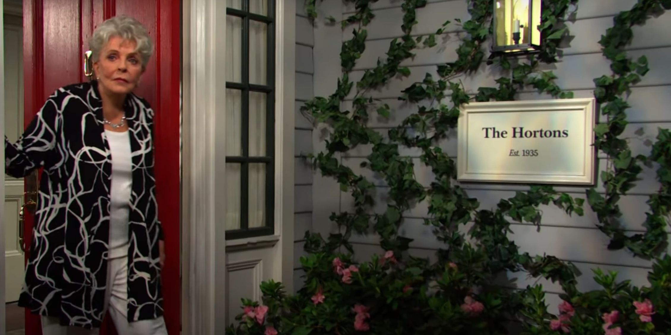 Julie stands in her doorway watching as Doug III goes